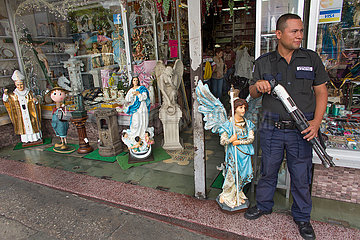 armed guard in front of a shop in guatamala city