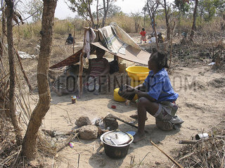 A family camps in the fields. Feeding centres and other humanitarian aid were organised in Angola after widescale malnutrition during and following the countrys civil war.