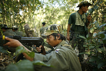 A KNLA soldier takes aim in the jungle around La Per Her. In Myanmar (Burma)  thousands of people have settled near the border as a result of oppression in their homeland. Around 200 Burmese displaced people have settled in La Per Her  a village on the Bu