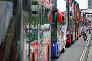 London  Grossbritannien  Fahrradfahrer fahren an im Stau stehenden Bussen vorbei