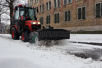 Berlin  Deutschland  Winterdienst befreit einen Gehweg vom Schnee