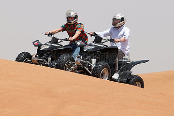 Dubai  Vereinigte Arabische Emirate  Jugendliche fahren auf Quads durch die Wueste