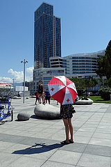 Batumi  Georgien  Frau steht mit einem Regenschirm in den Nationalfarben von Georgien in der Stadt