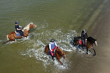 Dierhagen  junge Frauen reiten auf ihren Pferden in der Ostsee