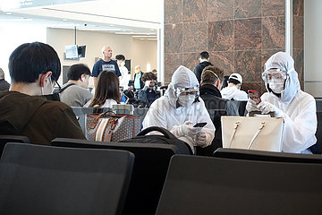 Atlanta  USA  Auswirkungen der Coronapandemie: Flugpassagiere sitzen im Schutzanzug mit Schutzbrillen und Atemmasken im Terminal des Flughafen
