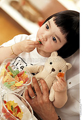 CHILD EATING SWEETS