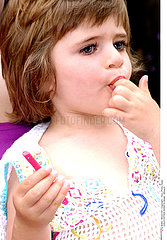 CHILD EATING SWEETS