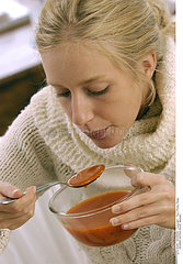 WOMAN EATING SOUP