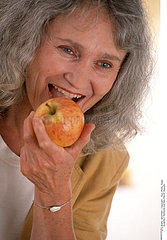 ELDERLY PERSON EATING FRUIT