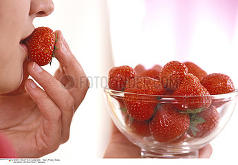 WOMAN EATING FRUIT