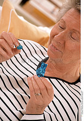 ELDERLY PERSON EATING SWEETS