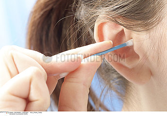 WOMAN CLEANING EARS