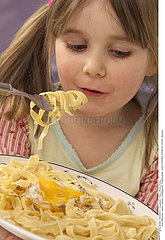 CHILD EATING STARCHY FOOD