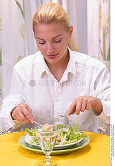 WOMAN EATING RAW VEGETABLES