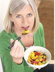 WOMAN EATING FRUIT