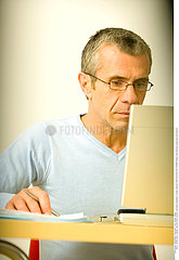 MAN FILLING OUT FORMS