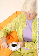 ELDERLY PERSON WITH HOT DRINK