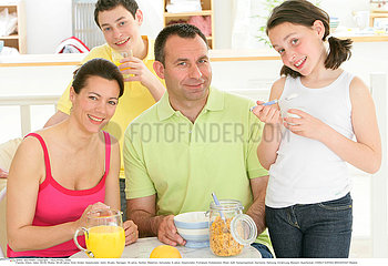 FAMILY EATING BREAKFAST