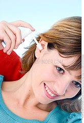 WOMAN CLEANING HER EARS