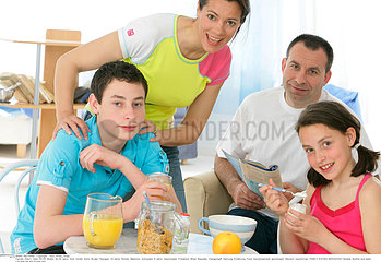 FAMILY EATING BREAKFAST