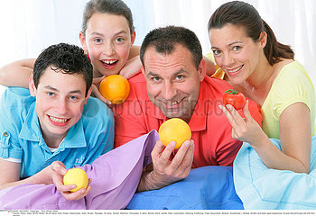 FAMILY EATING FRUIT