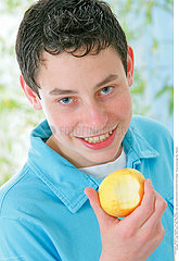 ADOLESCENT EATING FRUIT