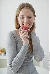 ADOLESCENT EATING FRUIT