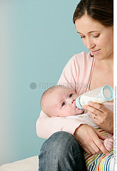 INFANT DRINKING FROM BABY BOTTLE