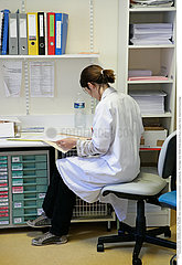 NURSE WITH PATIENT'S RECORD