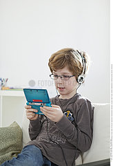 CHILD PLAYING WITH VIDEO GAME