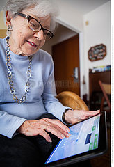 ELDERLY PERSON WITH TABLET