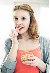 WOMAN EATING DRIED FRUIT