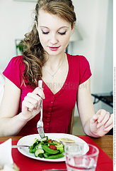 WOMAN EATING A MEAL