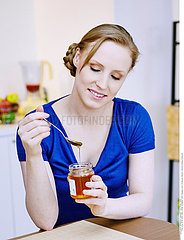 WOMAN EATING HONEY