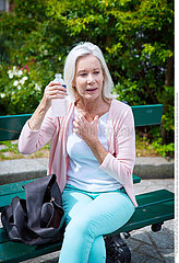 ELDERLY PERSON WITH COLD DRINK