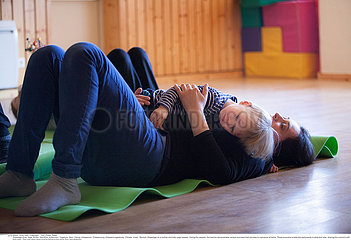 MOTHER AND CHILD PRACTICING YOGA