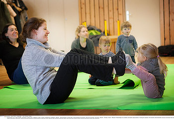 MOTHER AND CHILD PRACTICING YOGA