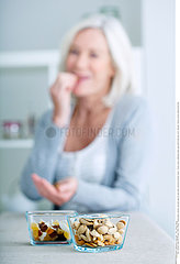 ELDERLY PERSON EATING DRIED FRUIT