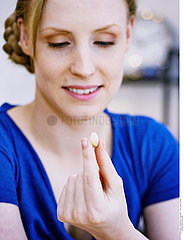 WOMAN EATING DRIED FRUIT