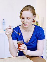 WOMAN EATING HONEY