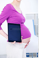 PREGNANT WOMAN WITH TABLET