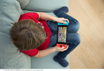 CHILD PLAYING VIDEO GAME