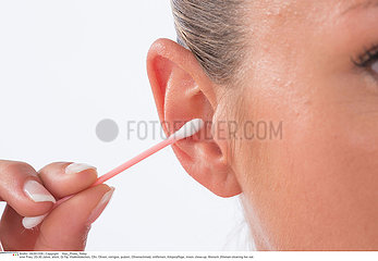 WOMAN CLEANING EAR