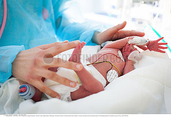 A nursery nurse takes care of a premature baby. Hospital. Aix en Provence.