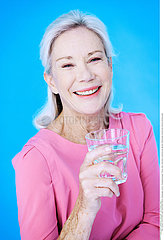 ELDERLY PERSON WITH COLD DRINK