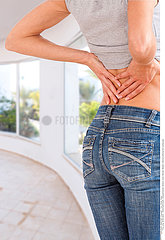 WOMAN WITH LOWER BACK PAIN