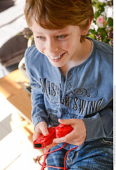 CHILD PLAYING WITH VIDEO GAME