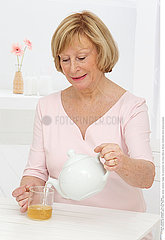 ELDERLY PERSON WITH HOT DRINK