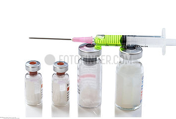Syringe on a white background on the top of the vial bottle