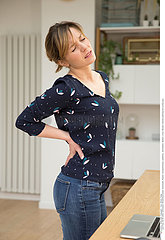 WOMAN WITH LOWER BACK PAIN
